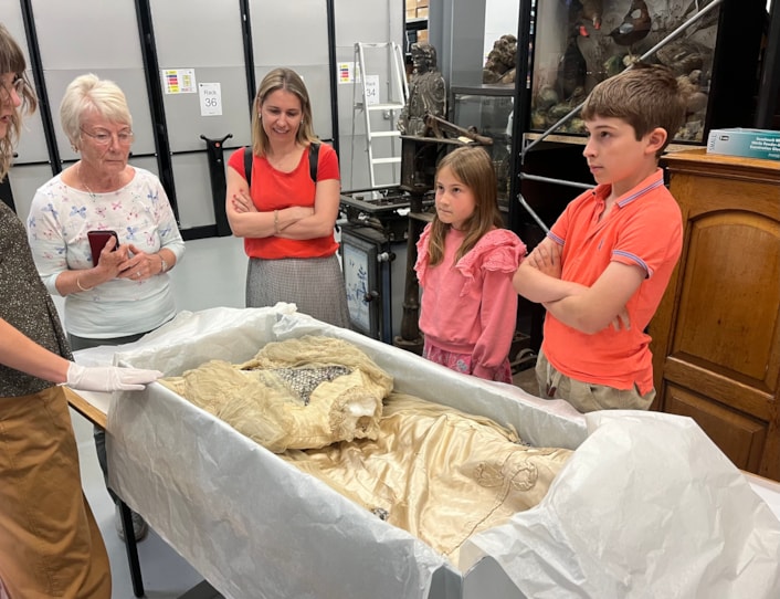 Lily Cathcart wedding dress: Sara Merritt (far left), Leeds Museums and Galleries' audience development officer, shows the precious wedding dress to (L-R) Jennifer Slater, Christina Bromley, Emmeline Bromley and Alexander Bromley, the family of Lily Cathcart.