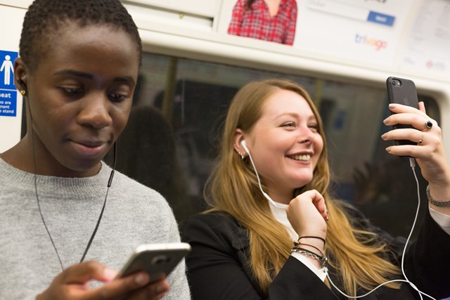 TfL Image - Customers using mobile phones on Tube train