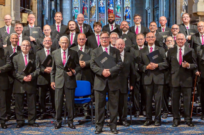 DPHAR 2026 - Leeds Male Voice Choir Crop: Colin Clark, pictured centre, surrounded by members of Leeds Male Voice Choir. Picture credit: Stage Shots Photography