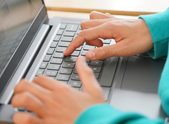 DisconnectToReconnectC: Image shows a close-up of a child's hands on a computer keyboard