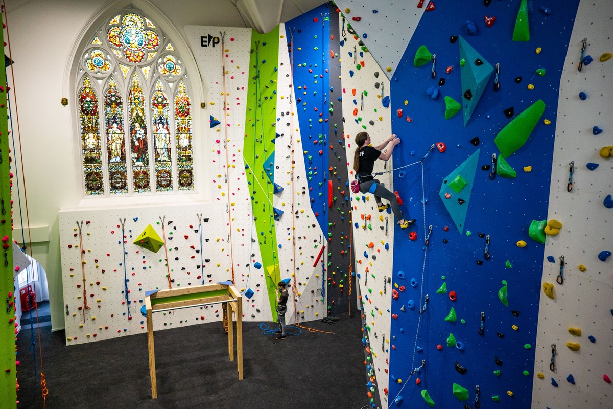 female climber scaling the wall