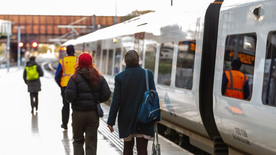 Image shows two customers boarding a Northern train