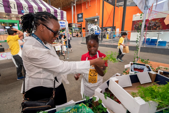 Young Marketeers 4: Councillor Nkele Manaka (Leeds City Council's deputy executive member for children and families) at the Young Marketeers event at Leeds Kirkgate Market.