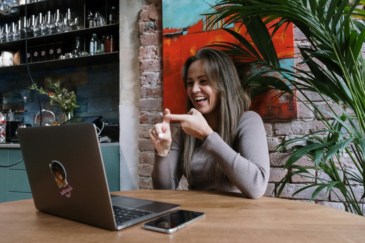 Lady using Sign Language into laptop