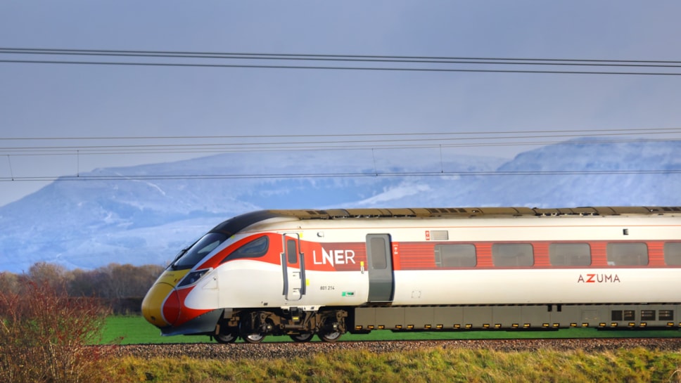 An LNER Azuma train passing through the countryside