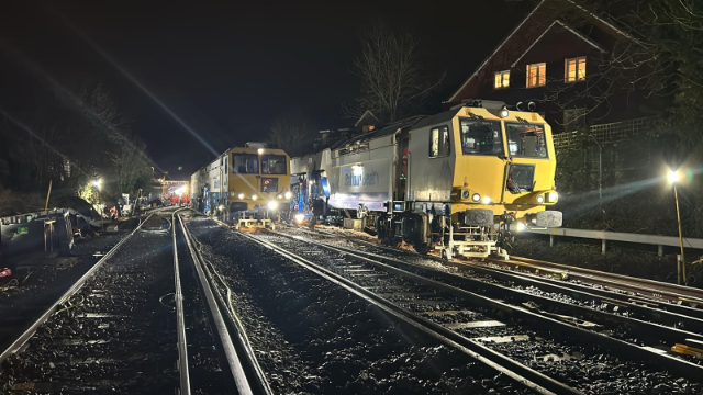 Rail customers urged to plan ahead this Easter as Network Rail carries out embankment stabilisation work between Axminster and Pinhoe and essential track upgrade work in the Staines area.: A tamping machine in action at night near Wokingham