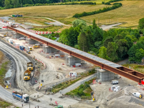 Aerial view of Lower Thorpe Viaduct deck installed in final position and vehicles on the temporary haul road June 2025