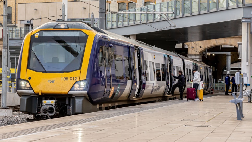 Image shows Northern train at platform with doors open