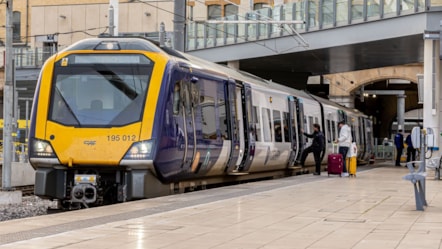 Image shows Northern train at platform with doors open