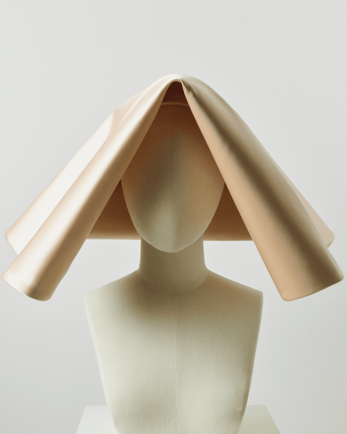 Image of a striking ivory cornette on a mannequin. 

Image Courtesy of JW Anderson.