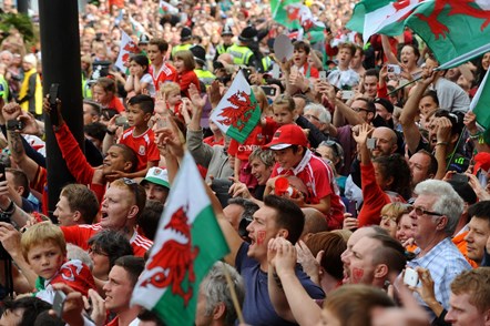 Red wall fans in the street with the Welsh flag prominent