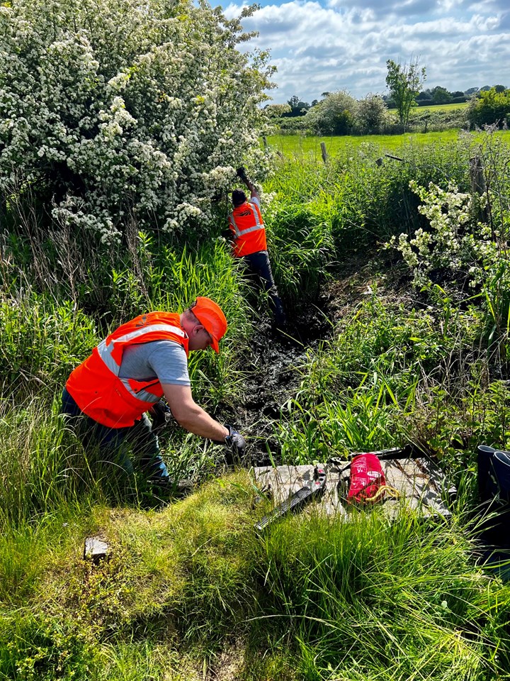 Volunteers clearing the feeder channel in Rugby