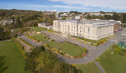 Golygfa uchel o Llyfrgell Genedlaethol Cymru gyda adeiladau eraill Aberystwyth yn y cefndir.