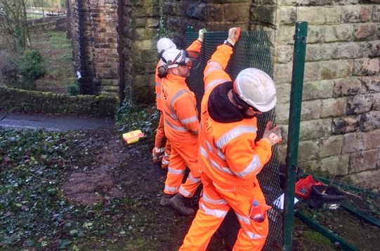 Network Rail workers installing more safety fencing at Den Lane in Uppermill 17 December 2018