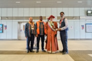 TfL Image - An actress from Zoom through History dressed as Suffragette leader, Emmeline Pankhurst with staff at Barking Riverside station: TfL Image - An actress from Zoom through History dressed as Suffragette leader, Emmeline Pankhurst with staff at Barking Riverside station