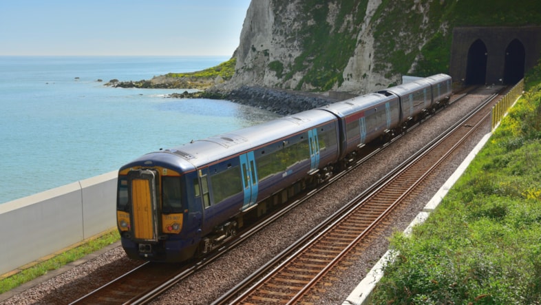 Ditch the car and explore the south-east by train this bank holiday weekend: A Southeastern train passing Shakespeare Beach in Dover