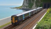 A Southeastern train passing Shakespeare Beach in Dover: A Southeastern train passing Shakespeare Beach in Dover