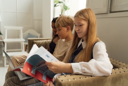 Teenagers reading on sofa