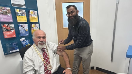 Deputy Mayor Councillor Mushtaq Hussain recives his vaccine at Well Pharmacy at The Northway from pharmacist Thanvir Choudhury