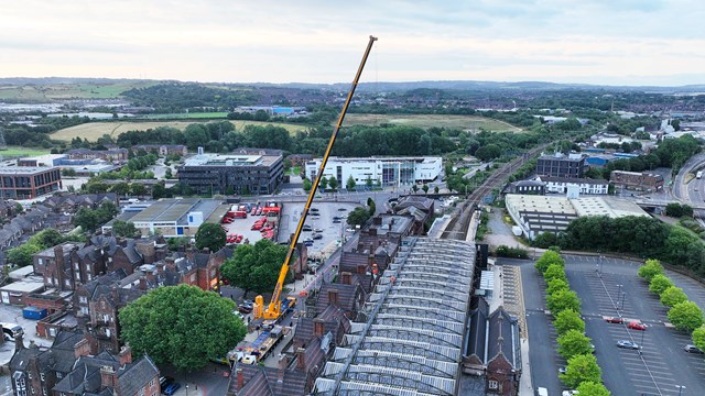 Aerial shot of crane and roof of Stoke on Trent station during repairs