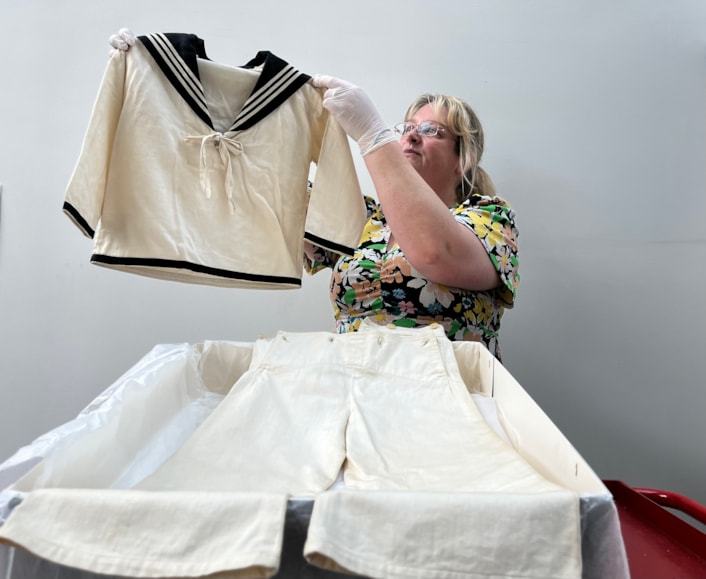 Sailor suits: Gemma Brown, site development officer at the Leeds Discovery Centre, with one of the eye-catching sailor suit style outfits in the Leeds collection.
The eye-catching naval attire includes a classic range of blue and white outfits, dresses and bellbottom trousers, looks which became hugely popular for children during the late 19th and early 20th centuries.
The suits are among an array of historic fashions which will be explored in an upcoming workshop at Leeds Discovery Centre looking back on centuries of fabulous clothes and costumes.