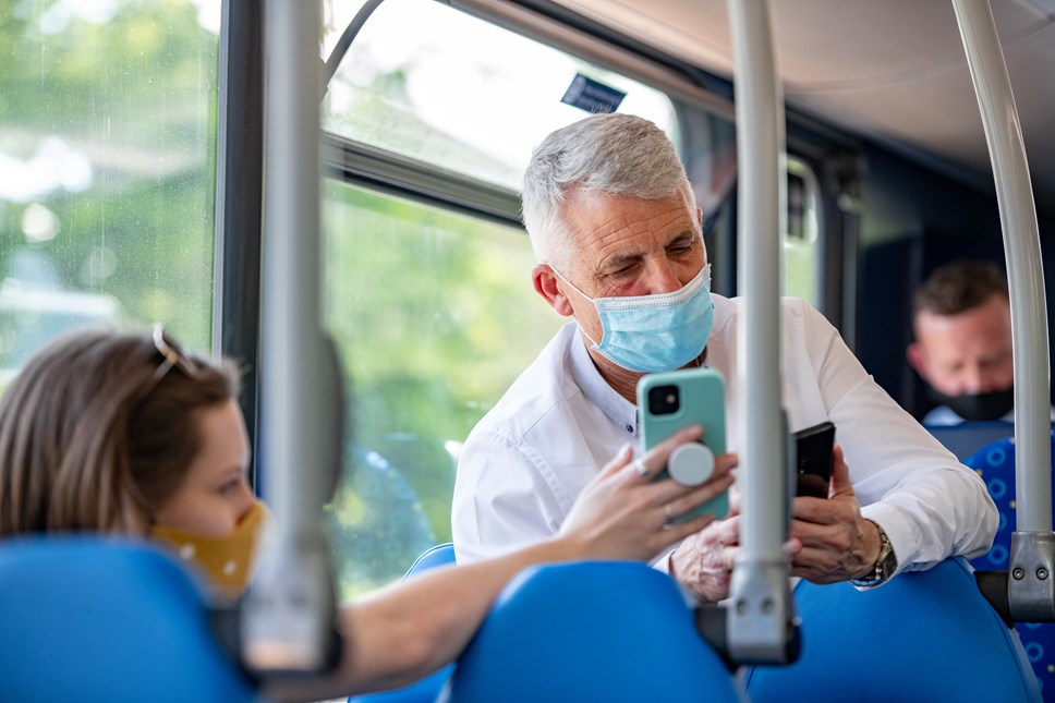 Male passenger on Metrobus wearing face covering