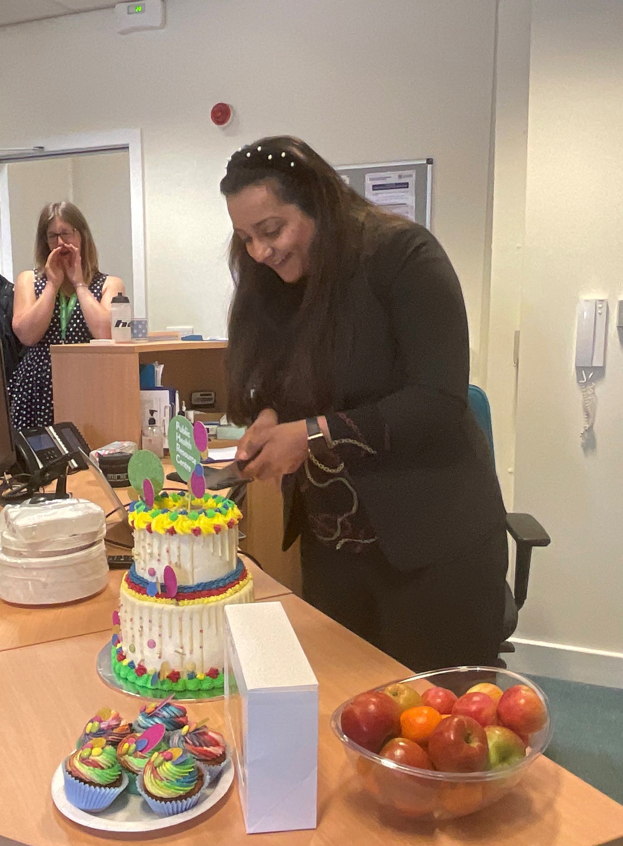 Cllr Arif cutting cake