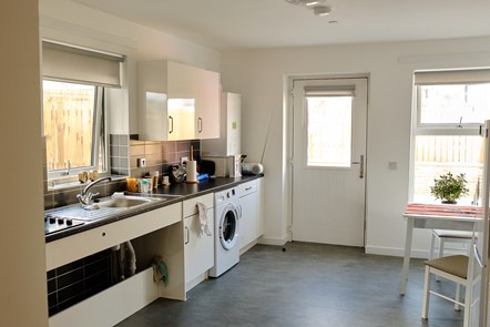 Specially adapted kitchen with adjustable sink and hob height for wheelchair users