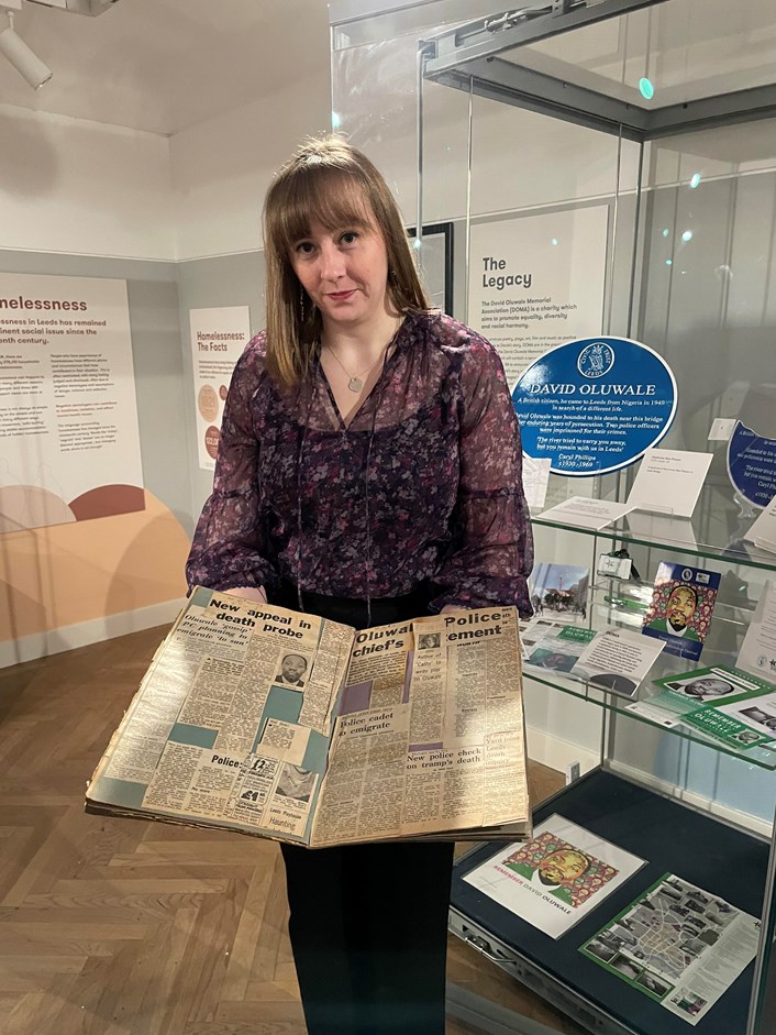 Overlooked: Lauren Theweneti from the Preservative Party with the original scrapbook created by Gary Galvin, the police officer who notified West Yorkshire Police of David Oluwale's abuse.