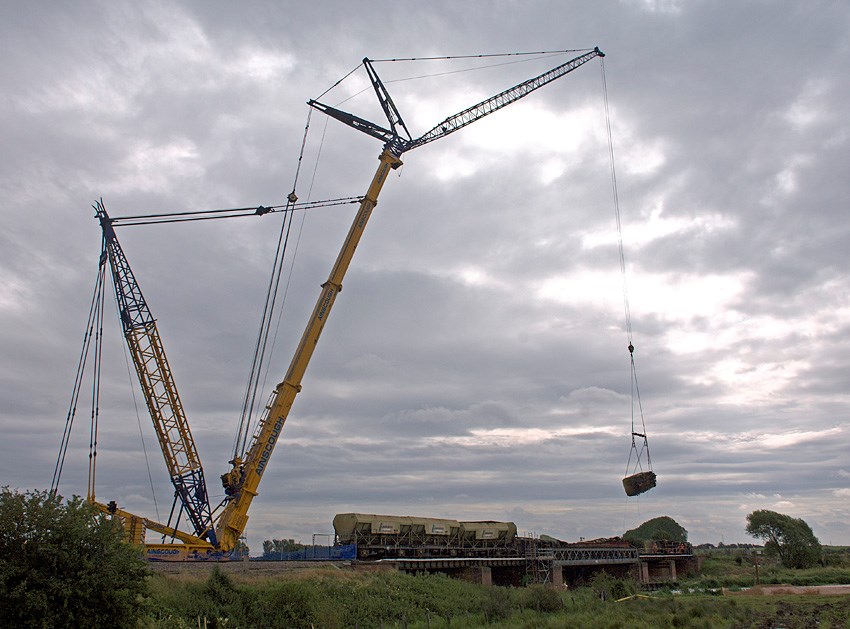FREIGHT WAGONS LIFTED FROM ELY RAIL BRIDGE : Wagons are lifted from the damaged Ely rail bridge