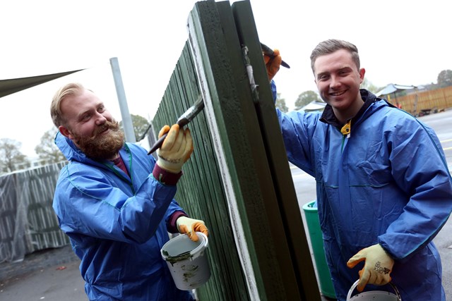 Crawley school playground makeover is on track: Volunteers from the Thameslink Programme painting a fence at Manor Green College