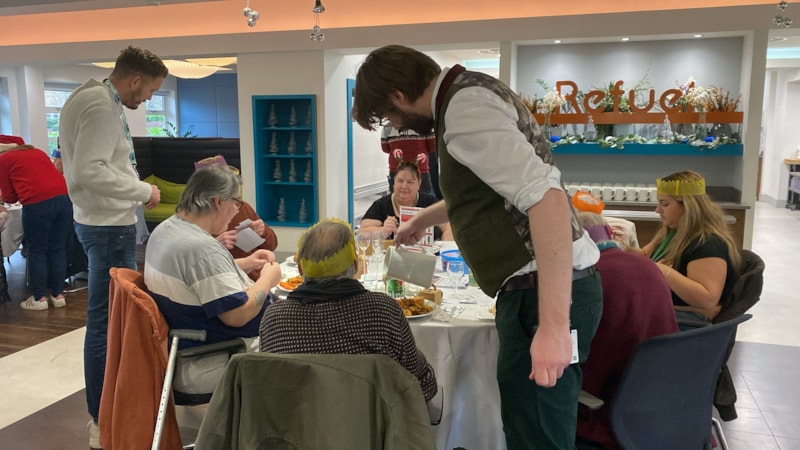 BristolChristmas2024-james: James pouring gravy for guests at the Christmas lunch