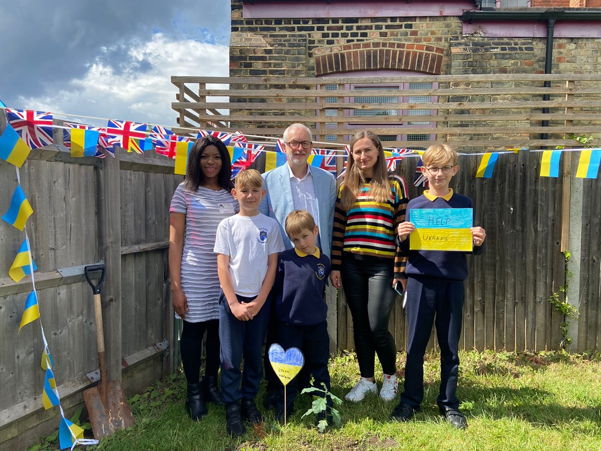 With the newly-planted oak sapling at Christ The King Catholic Primary School are, from left, Cllr Michelline Ngongo, Osap, Jeremy Corbyn MP, Nikita, Yulia and Denys