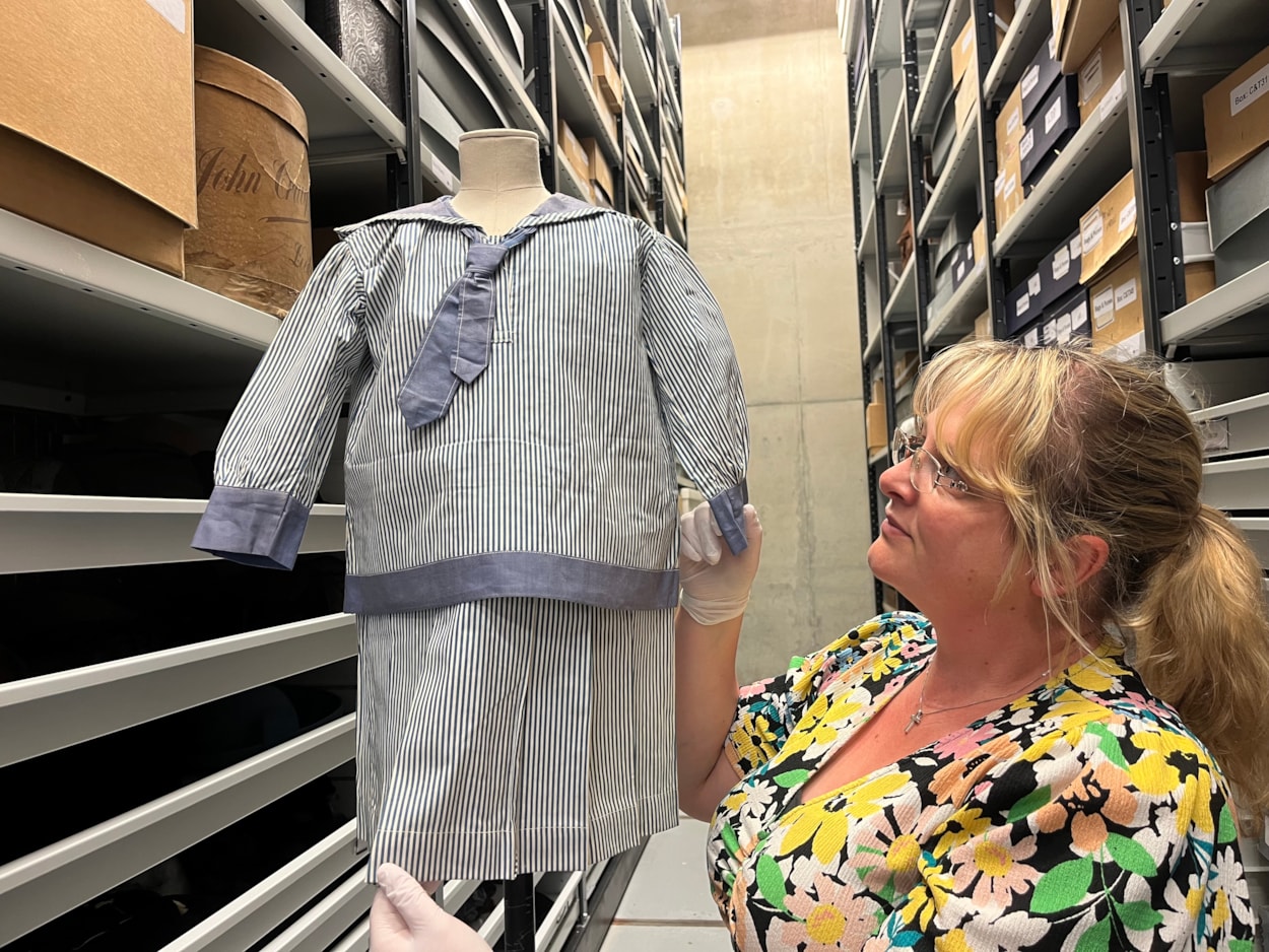 Sailor suits: Gemma Brown, site development officer at the Leeds Discovery Centre, with one of the eye-catching sailor suit style outfits in the Leeds collection.
The eye-catching naval attire includes a classic range of blue and white outfits, dresses and bellbottom trousers, looks which became hugely popular for children during the late 19th and early 20th centuries.
The suits are among an array of historic fashions which will be explored in an upcoming workshop at Leeds Discovery Centre looking back on centuries of fabulous clothes and costumes.