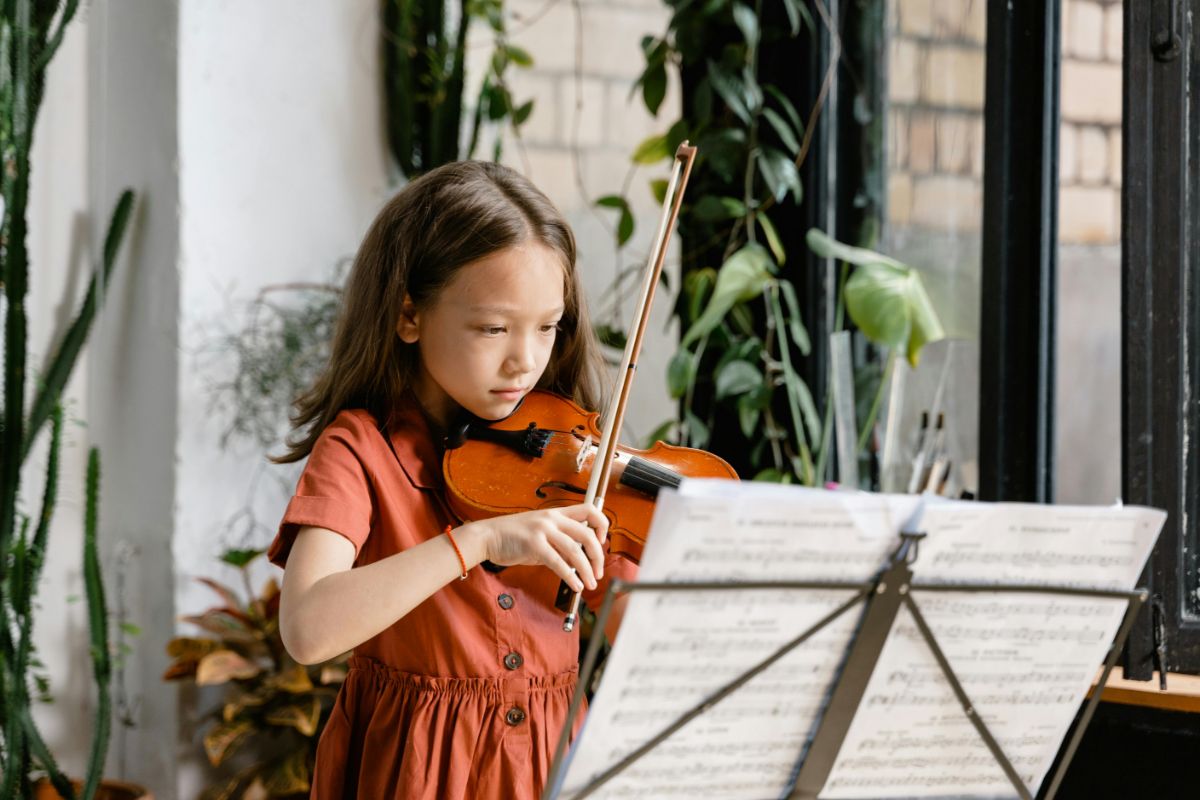 young girl playing a violin credit pexels-mart-production-8471931