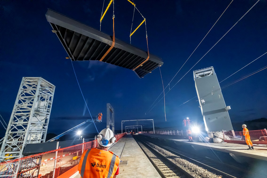 Reston Station footbridge installation: Main footbridge span being craned into position over the East Coast Mainline