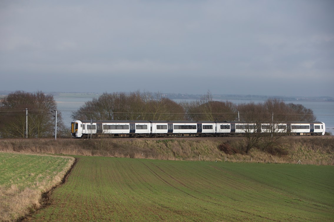 Battery-powered train (IPEMU) cutting through Essex countryside: The new train contributes to Network Rail’s commitment to reduce its environmental impact, improve sustainability and reduce the cost of running the railway by 20 per cent over the next five years. It could ultimately lead to a fleet of battery-powered trains running on Britain’s rail network which are quieter and more efficient than diesel-powered trains, making them better for passengers and the environment. Network Rail and its industry partners – including Bombardier, Abellio Greater Anglia, FutureRailway and the Rail Executive arm of the Department for Transport (which is co-funding the project) – recognise the potential for battery-powered trains to bridge gaps between electrified parts of the network and to run on branch lines where it would be too expensive to install overhead electrification.