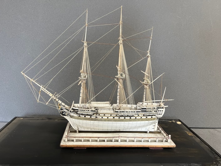 Model ships: An intricate model ship carved from bone by a French prisoner during the Napoleonic Wars.
Complete with an elaborate figurehead, planked deck and carved helm with a steering gear and compass box, the bone model dates from the early 19th century and is believed to be an example of the type carved by French captives held in British prisons and aboard ships.