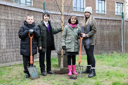 Children at Hugh Myddelton Primary School planting a tree from the Forest for Change exhibion in November 2021