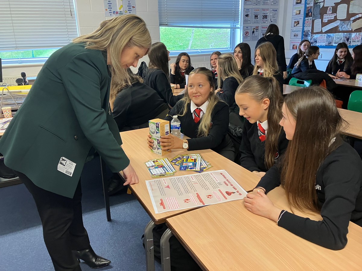 Deputy Minister Hannah Blythyn talking to pupils at period dignity school visit in classroom