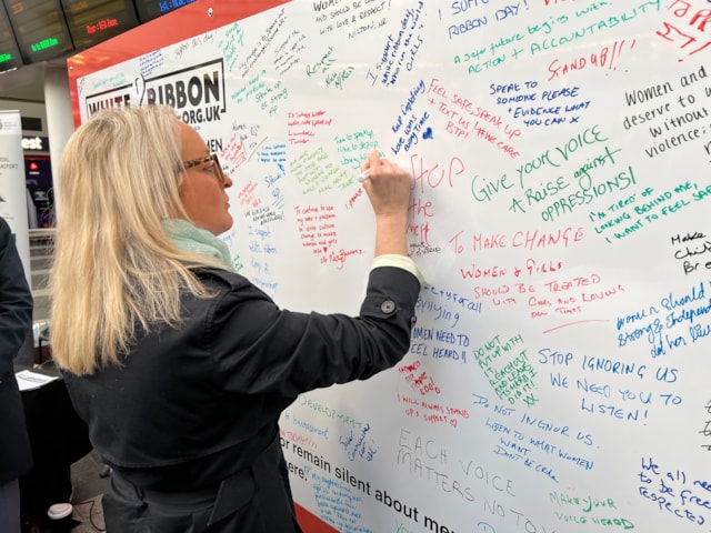 Denise Wetton, route director for Network Rail Central route, signing the White Ribbon pledge wall: Denise Wetton, route director for Network Rail Central route, signing the White Ribbon pledge wall