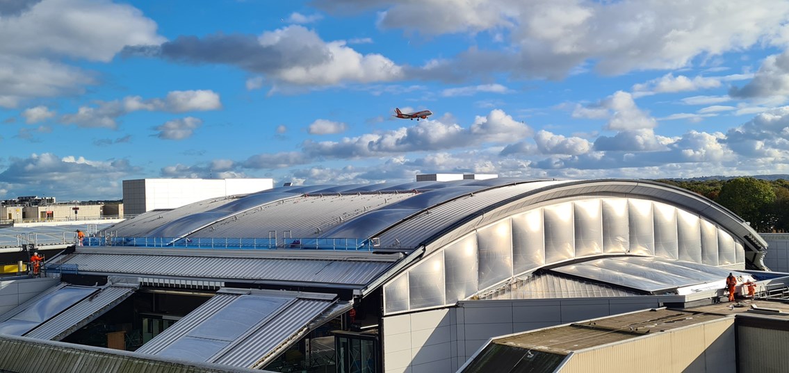 A plane arriving at Gatwick Airport above the new concourse