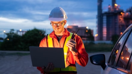 Engineer in hard hat with laptop