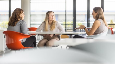 Apprentices talking in office