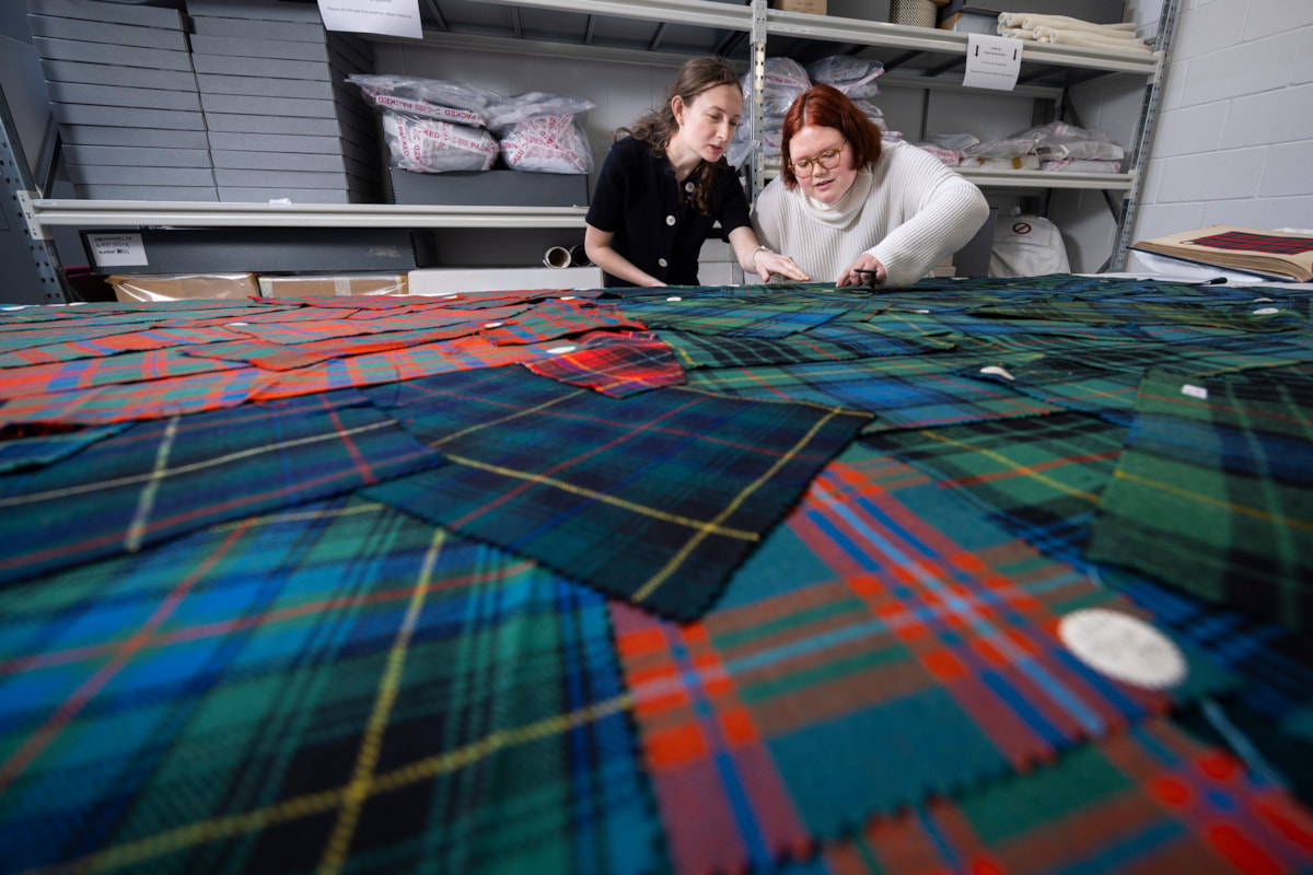University of Glasgow students Lilly and Layla examine tartan samples. Photo © Duncan McGlynn (1)