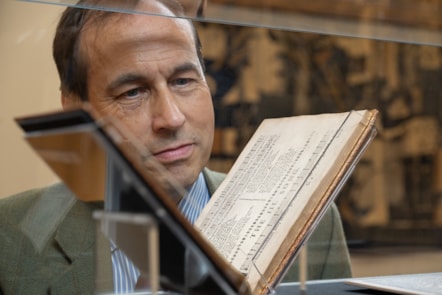Councillor Martin Greig with Songs and Fancies. Credit Aberdeen City Council – Archives, Gallery & Museums