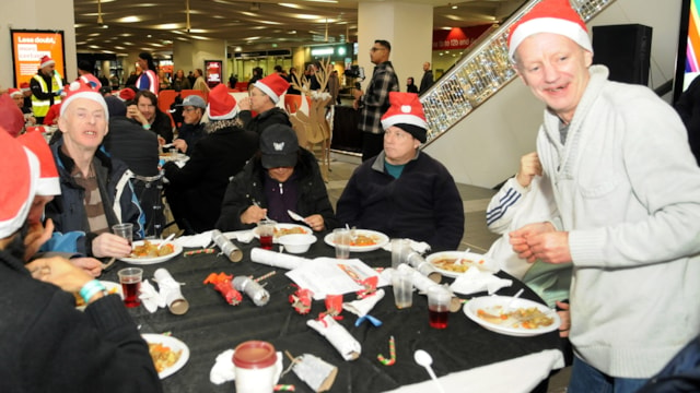 A festive feast for those in need in Birmingham this Christmas: Enjoying a hot meal at Birmingham New Street Christmas Eve 2023