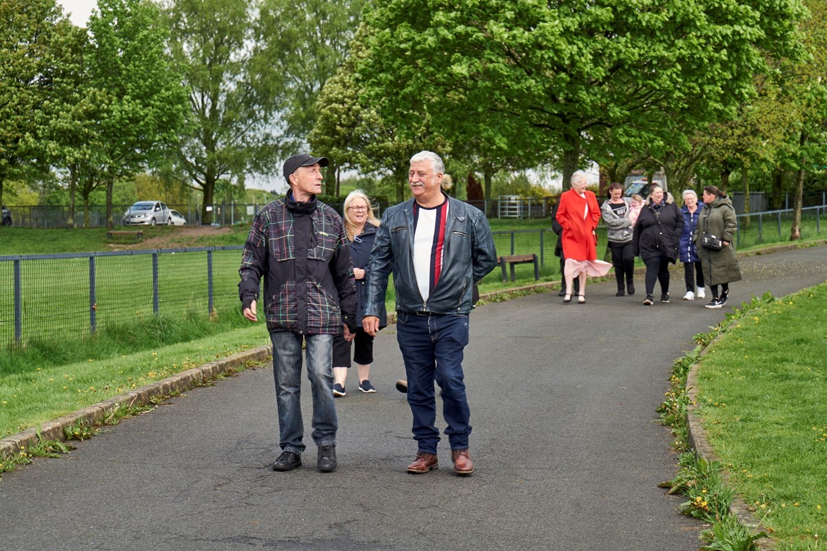 People walking through park