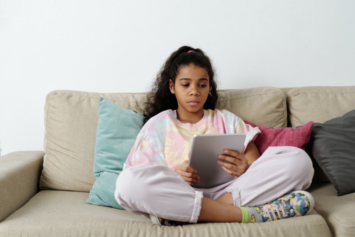 girl-in-pink-shirt-sitting-on-couch-4144042