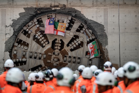 Team flags shown through giant cutterhead of HS2 Tunnel Boring Machine Mary Ann that completed first tunnel breakthrough in Birmingham: With team flags from Malaysia, Donegal, England and Wales